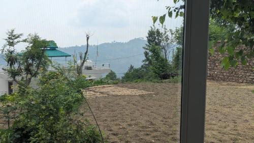 a view from the window of a house at Mayur Home Stay, Morni Hills in Morni