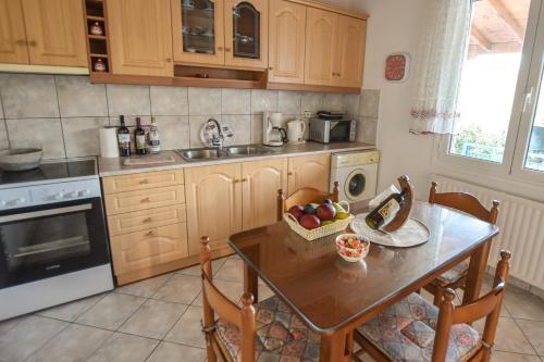 a kitchen with a table with a bowl of fruit on it at Εξοχική κατοικία Αnna's house in Agía Zóni
