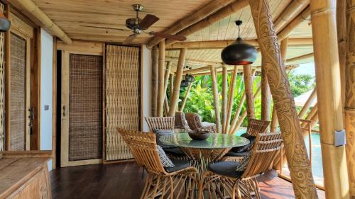an outdoor patio with a table and chairs at Villas Bukit Lipah in Amed