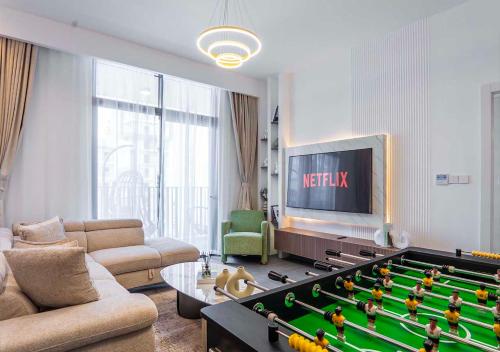 a living room with a large pool table in it at Royal Vista - Luxury 1BR Apartments at Kensington Waters in Dubai