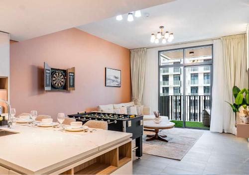a kitchen and living room with a large window at Royal Vista - Luxury 1BR Apartments at Kensington Waters in Dubai
