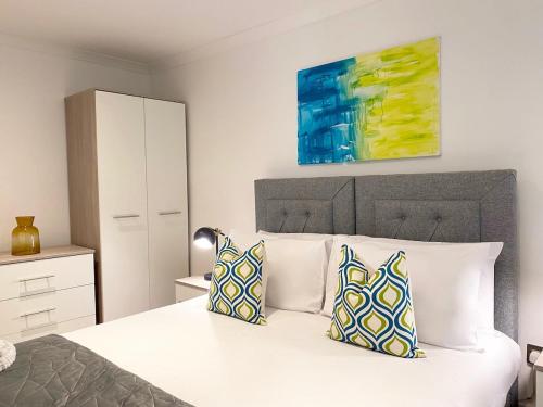 a bedroom with a white bed with two pillows at Modern-Comfy home in Appleby-in-Westmorland, Wi-Fi & Parking in Kirkby Thore