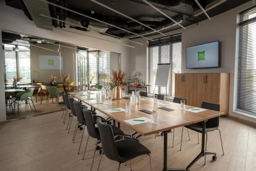 a large conference room with a long table and chairs at ibis Styles Debrecen Airport in Debrecen