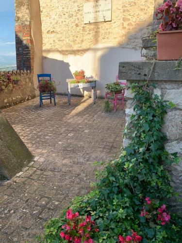 a patio with a table and chairs and flowers at Casa Romantica in Artena