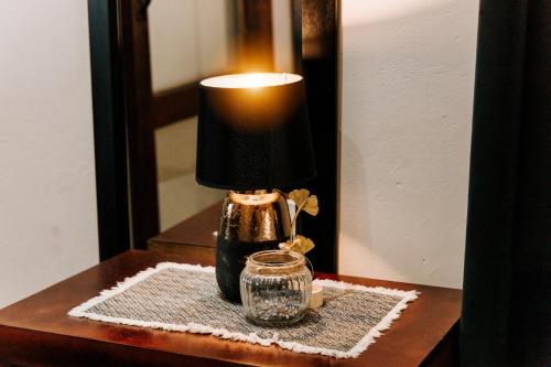 a lamp on a table in front of a mirror at Serene Guesthouse in Middelburg