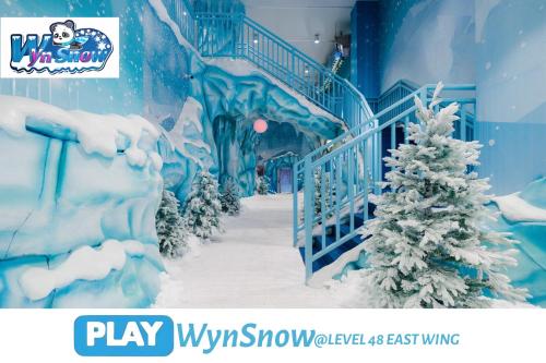 a fake snow covered staircase with a christmas tree at Wyndham Suites KLCC in Kuala Lumpur