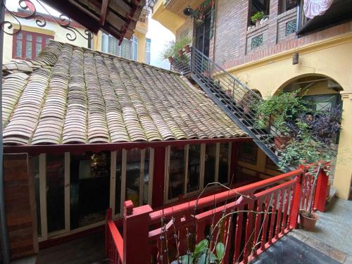 a building with a roof with a staircase on it at La Maison d'art de Hanoi in Hanoi