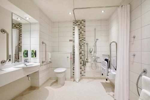 a bathroom with a toilet and a sink and a shower at Premier Inn Dublin City North Docklands in Dublin