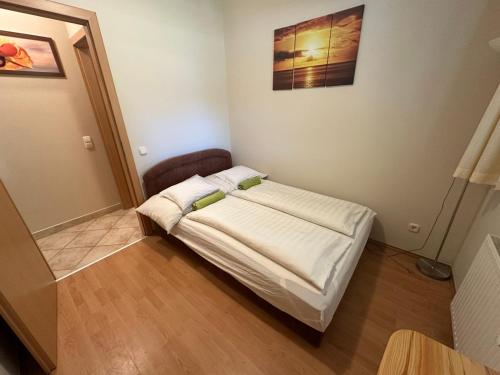 a small bedroom with a bed in a room at Palazzo Deluxe in Siófok