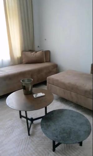a living room with a couch and a coffee table at La Maison des Fleurs FREE PARKING in Pazardzhik