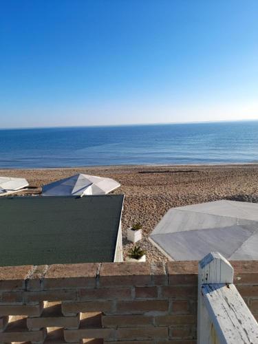 a view of the beach with the ocean in the background at VirgolaZero1 in Porto Potenza Picena