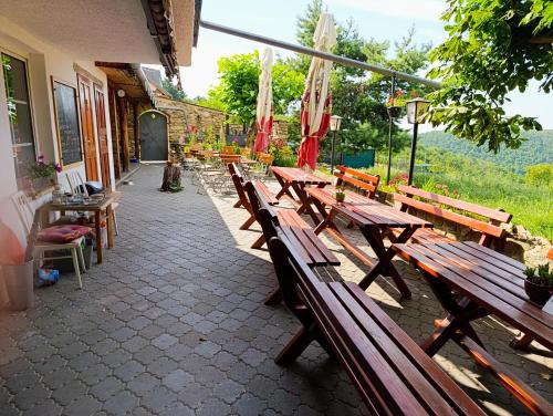 a row of wooden benches sitting outside of a building at Ubytování v soukromí ZuPa Znojmo 