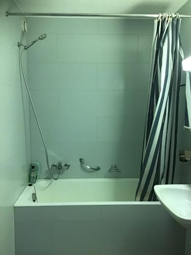 a bathroom with a bath tub and a sink at Appartement avec vue imprenable in La Tzoumaz