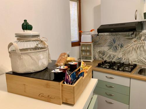 a kitchen with a counter top with a container on it at Old Porlezza Apartment in Porlezza