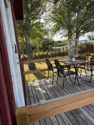 a patio with a table and chairs on a deck at Solstickan Hotell & Vandrarhem in Mellbystrand