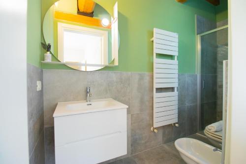 a bathroom with a sink and a mirror at fantastic lake view and pool, Primo sole in Barcuzzi