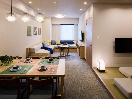 a living room with a table and a couch at Minn Ueno Shin-Okachimachi in Tokyo