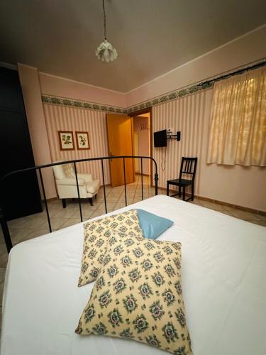 a bedroom with a white bed with a pillow on it at Camere In Centro in Agropoli
