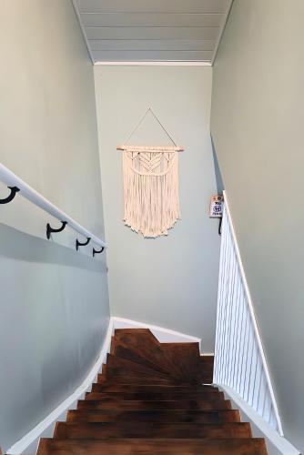 a staircase with white walls and wooden floors at L Orchidée in Dinant