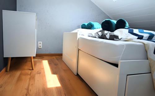a bedroom with a white bed with a drawer at L Orchidée in Dinant