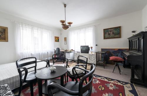 a living room with a table and chairs and a couch at Penzion U Zámeckého parku in Žihobce