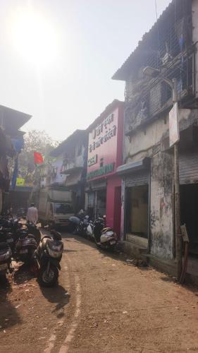 a group of motorcycles parked next to a building at Ahlan Green Apple Dormitory in Mumbai