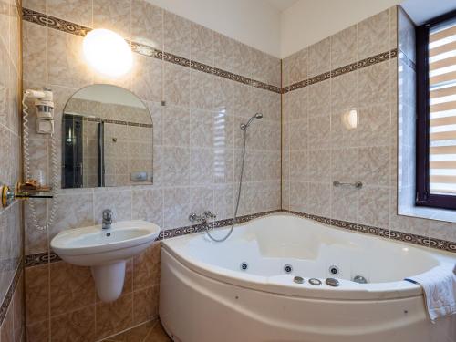 a bathroom with a bath tub and a sink at Zamek w Krasiczynie in Krasiczyn