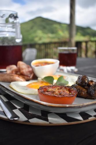 a plate of food on a table with food at Duiker Game Lodge in Hluhluwe