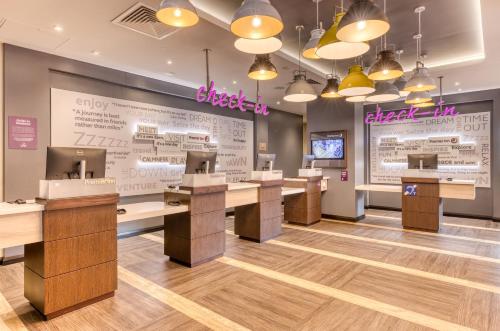 a lobby of a restaurant with desks and avertisement at Premier Inn Dublin City North Docklands in Dublin