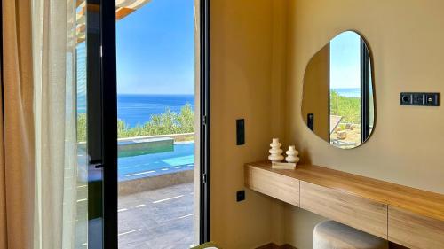 a bathroom with a mirror and a view of the ocean at Villa Keras With Sea View in Keratokampos