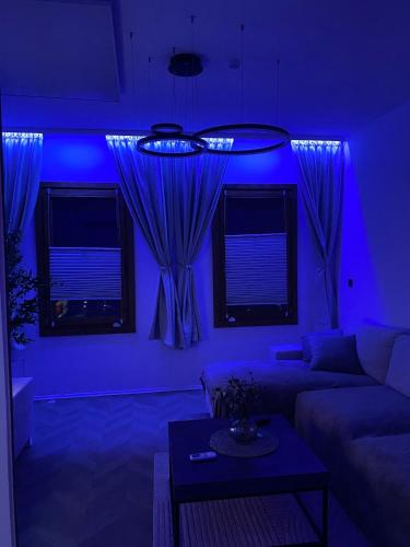 a blue room with a couch and a table at Casa Cabini Piave in Eraclea
