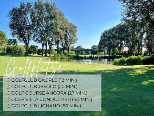 a sign in front of a park with a lake at Casa Cabini Piave in Eraclea