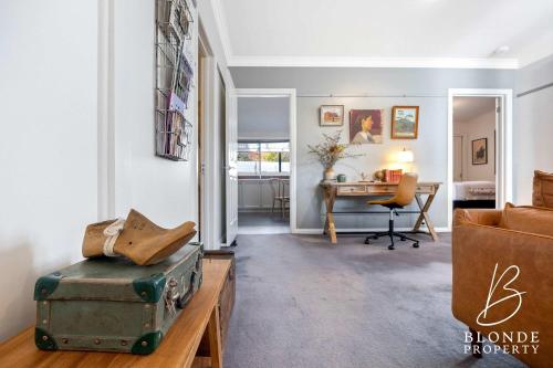 a living room with a couch and a table at Journeyman's Cottage in Ballarat
