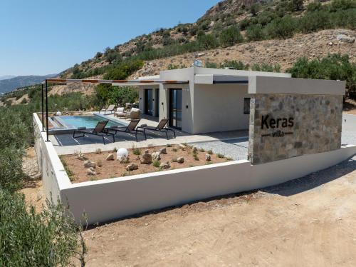 a house on the side of a hill at Villa Keras With Sea View in Keratokampos