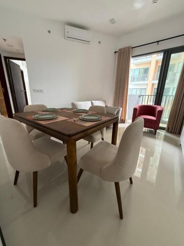 a dining table and chairs in a living room at Colombo, Trizen Luxury Apartments, Sri Lanka in Colombo