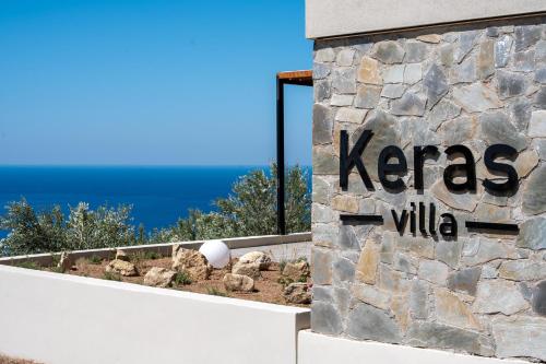 a sign for a keas villa on the side of a building at Villa Keras With Sea View in Keratokampos
