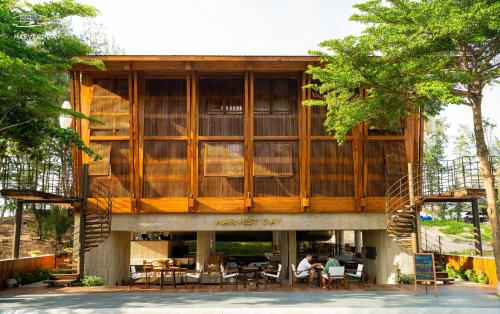 a large building with people sitting at tables at Harvest Day Hoi An in Hoi An