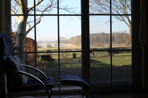 a room with a window looking out at a field at Ferienhaus Am See In Blankensee Groß Schönfeld in Blankensee