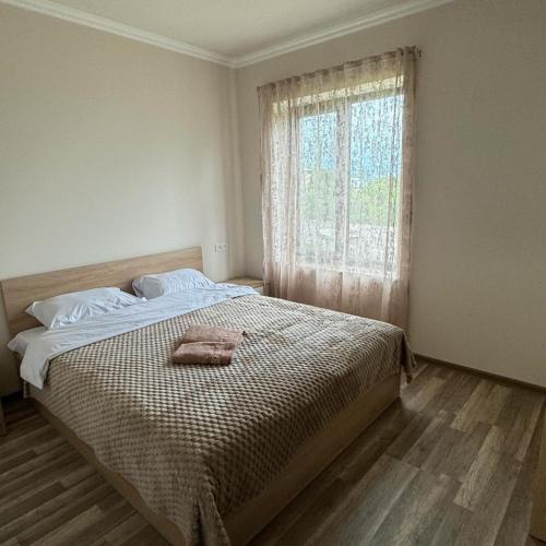 a bedroom with a large bed and a window at Armenia RENT HOUSE Byurakan in Byurakan