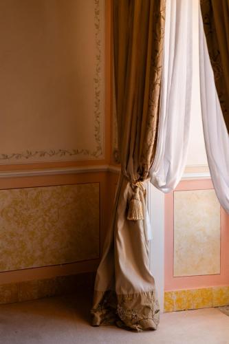 a curtain in a room with a window at Valverde Sintra Palácio de Seteais - The Leading Hotels of the World in Sintra