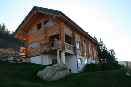 a large wooden house with a balcony on a hill at Ferienhaus In Pruggern Mit Terrasse Und Garten in Pruggern
