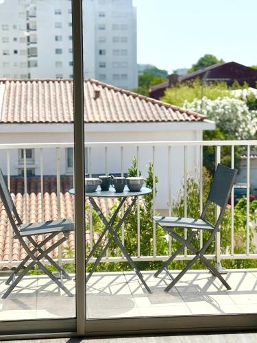 a table and two chairs on a balcony at Le Spacieux - Royan, Wifi & Balcon in Royan