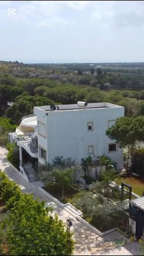 an aerial view of a white building at Dar El Bondek companion pool jacuzzi forest in Beni Khiar