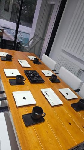 a long wooden table with black bowls and papers on it at Dar El Bondek companion pool jacuzzi forest in Beni Khiar
