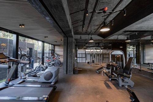 a gym with a bunch of treadms and cardio machines at Staylah Sanctuary 1br in Wilma Tower Apartment- Kilimani in Nairobi