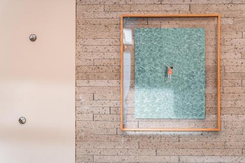 a person standing in the water in a pool at Hotel Palace Gyeongju in Gyeongju