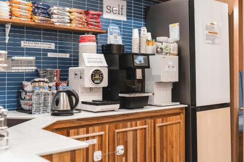 a kitchen with a coffee maker on a counter at Hotel Palace Gyeongju in Gyeongju