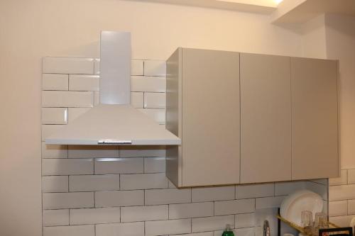 a kitchen with a silver stove top oven at Staylah Sanctuary 1br in Wilma Tower Apartment- Kilimani in Nairobi