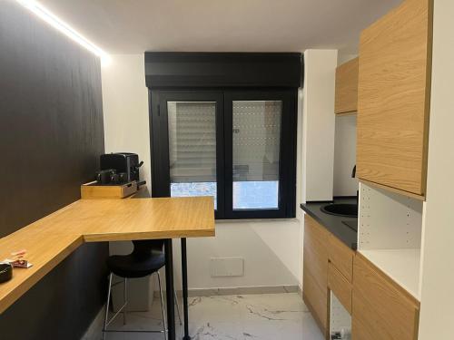 a small kitchen with a counter and a window at Suit home Archimede in Palermo