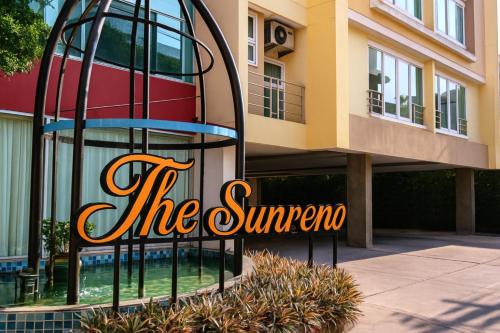 a building with a sign that reads the sun supreme at The Sunreno Hotel Bangkok in Bangkok